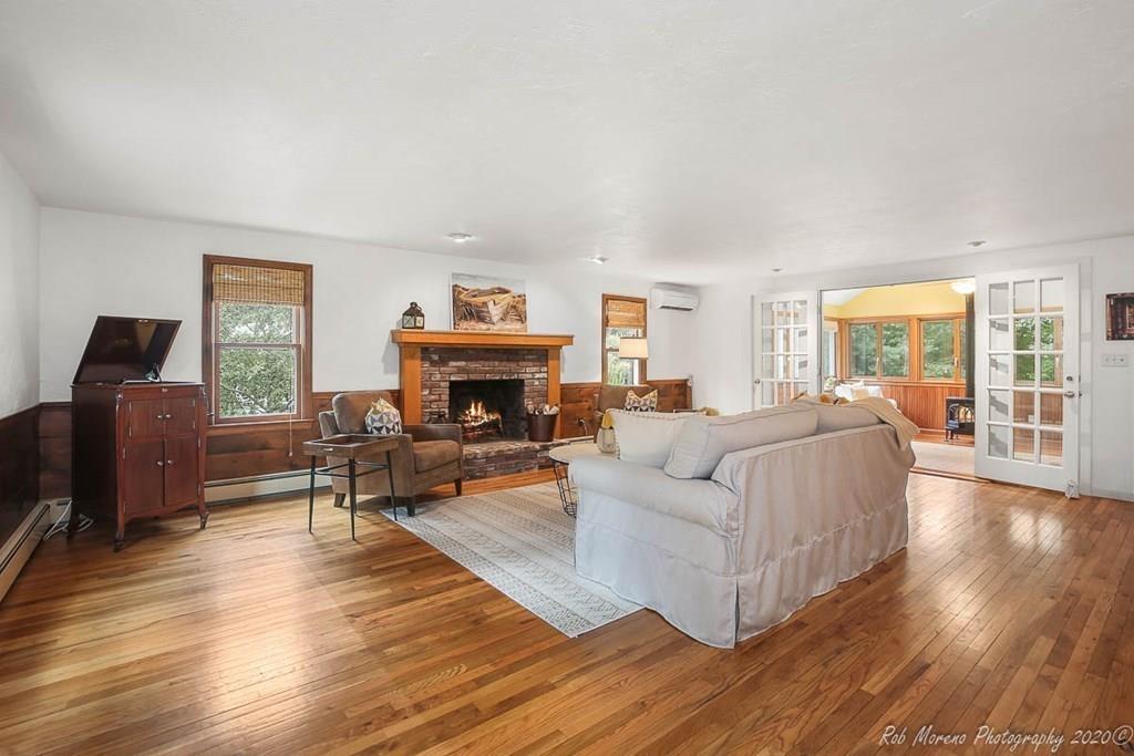 8 Curtis Road Boxford, MA 01921 - Photo 12 of 42 a living room with furniture a fireplace a flat screen tv and windows