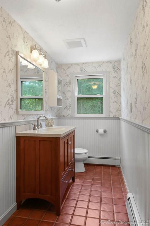 8 Curtis Road Boxford, MA 01921 - Photo 17 of 42 a bathroom with a sink toilet a mirror and window