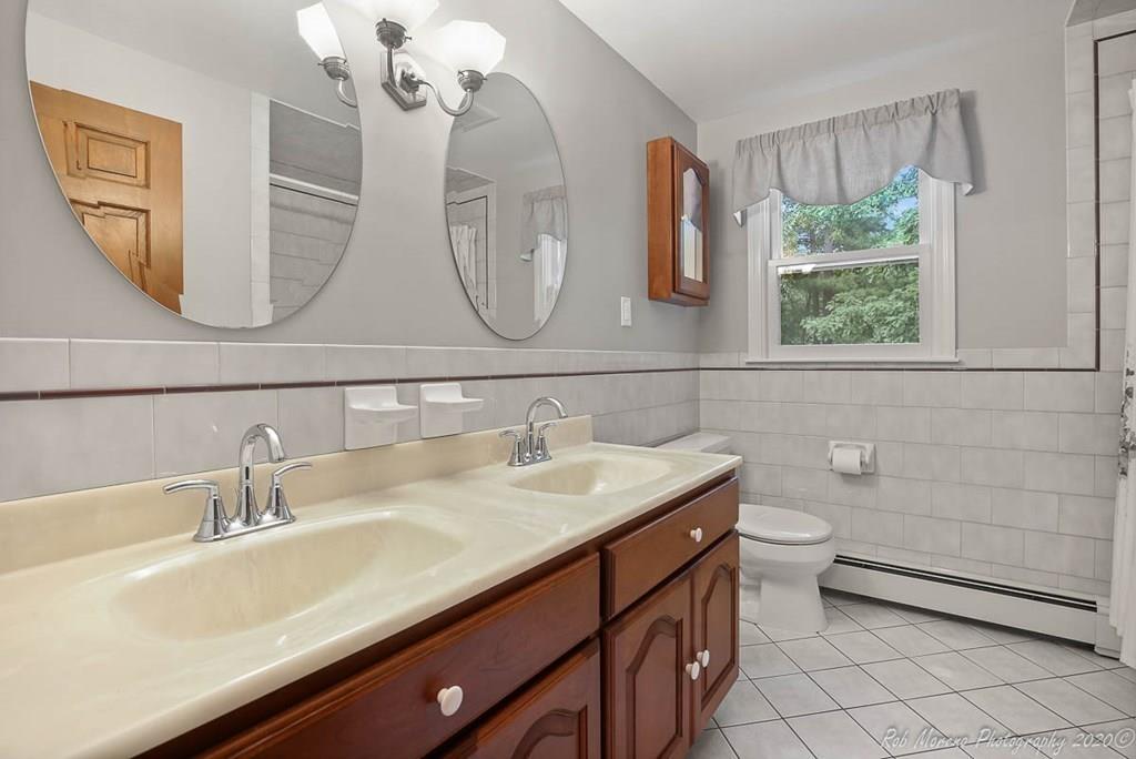 8 Curtis Road Boxford, MA 01921 - Photo 20 of 42 a bathroom with a double vanity sink and a mirror