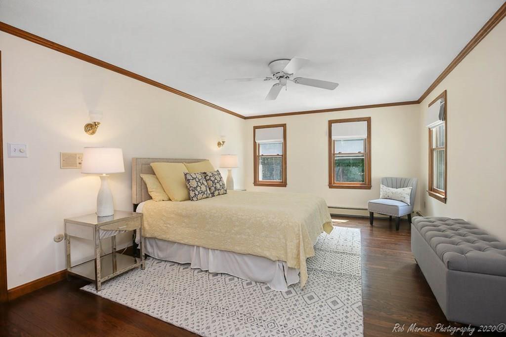 8 Curtis Road Boxford, MA 01921 - Photo 24 of 42 a bedroom with a large bed and wooden floor