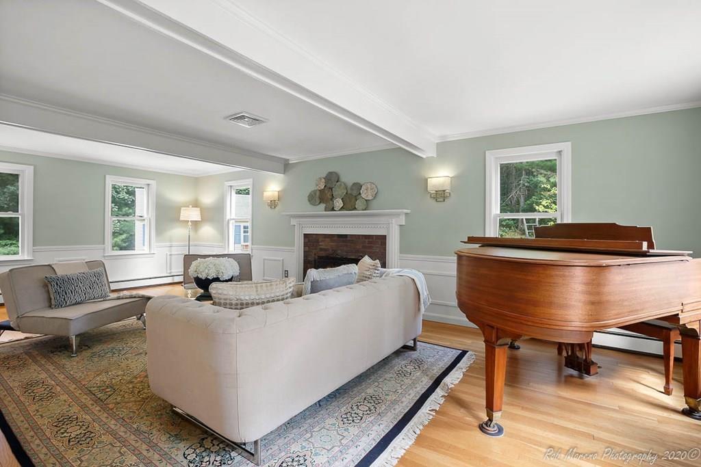 8 Curtis Road Boxford, MA 01921 - Photo 3 of 42 a living room with furniture a fireplace and a table