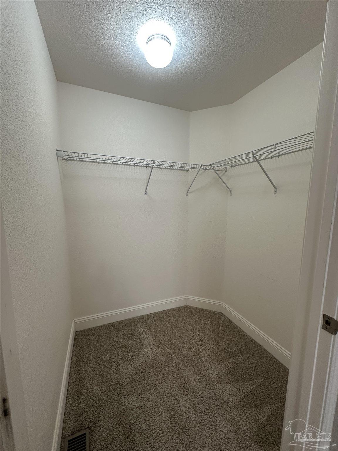 6250 Hamilton Bridge Road, Unit B Milton, FL 32570 - Photo 12 of 16 a view of a room with racks on the wall