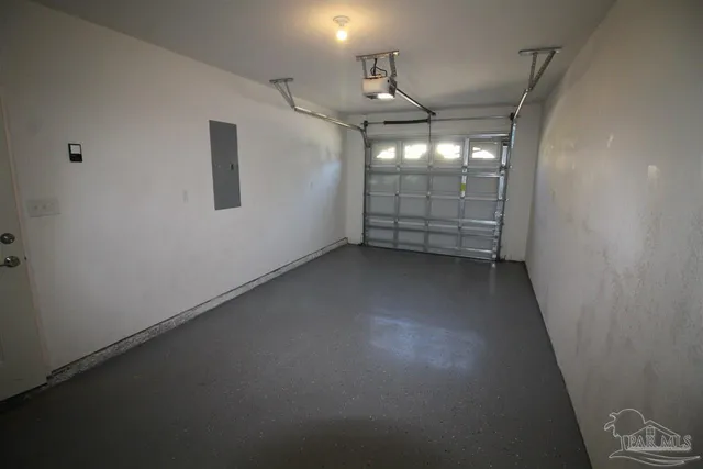 an empty room with windows and ceiling fan