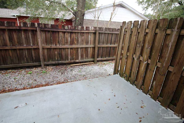 a view of a backyard with wooden fence