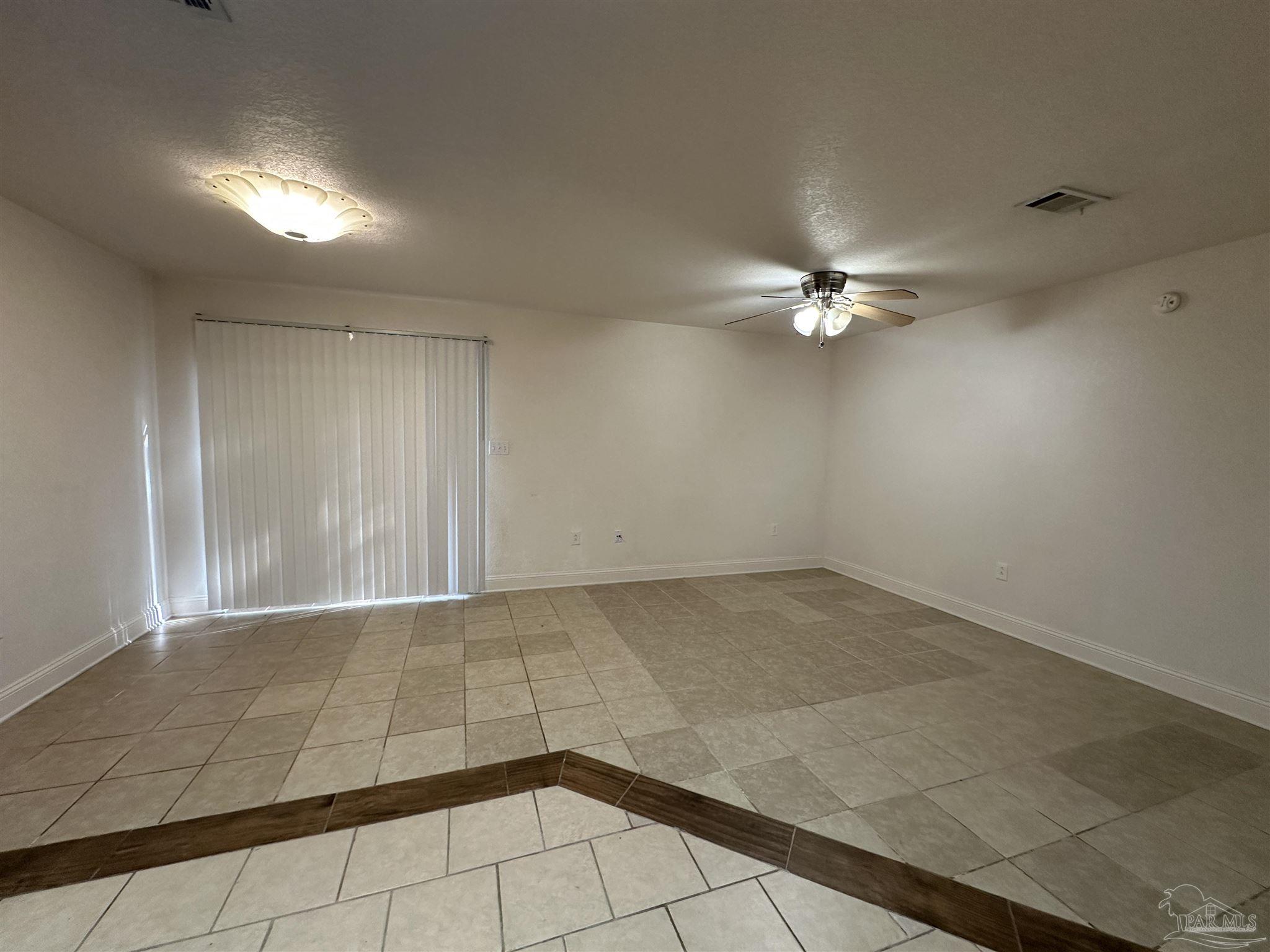 6250 Hamilton Bridge Road, Unit B Milton, FL 32570 - Photo 3 of 16 an empty room with a ceiling fan and chandelier fan