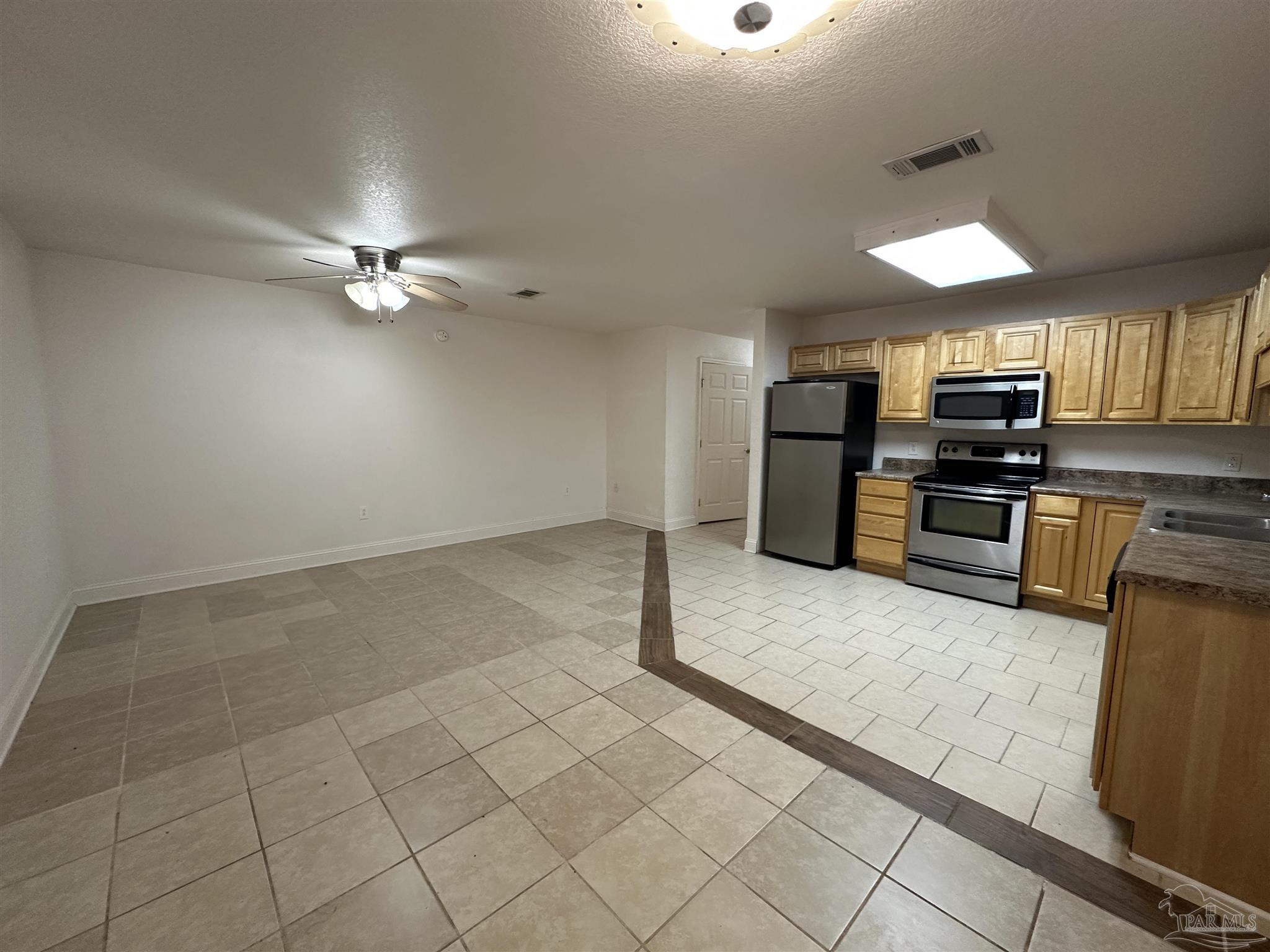 6250 Hamilton Bridge Road, Unit B Milton, FL 32570 - Photo 4 of 16 an open kitchen with refrigerator and microwave