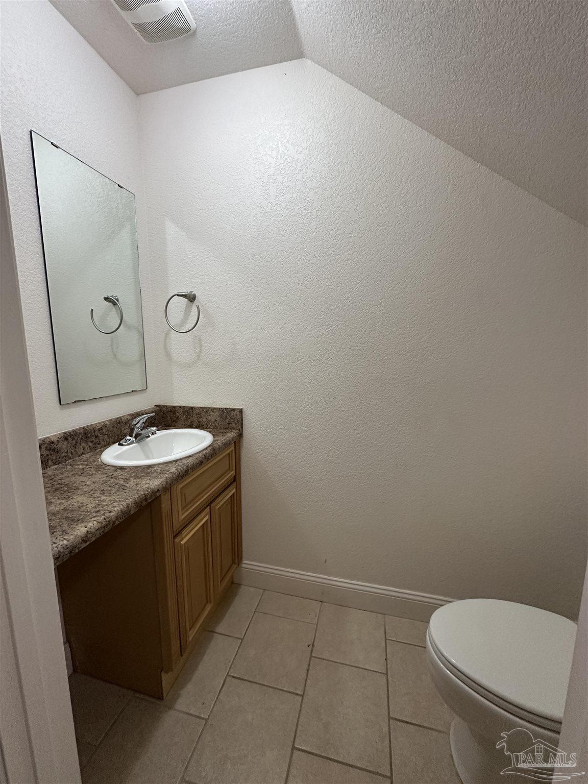 6250 Hamilton Bridge Road, Unit B Milton, FL 32570 - Photo 5 of 16 a bathroom with a granite countertop sink toilet and a mirror