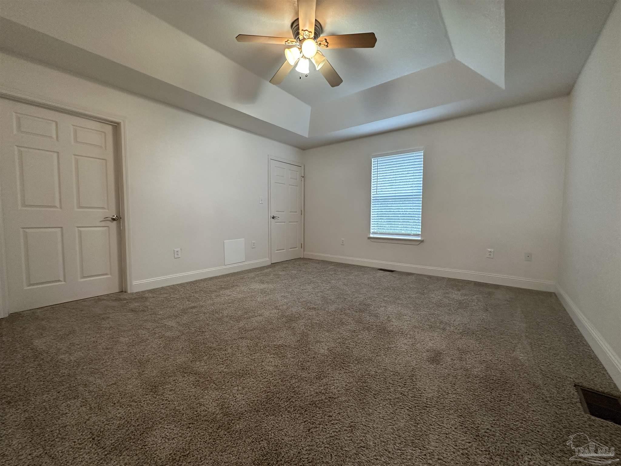 6250 Hamilton Bridge Road, Unit B Milton, FL 32570 - Photo 6 of 16 an empty room with windows and fan