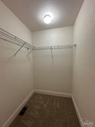 a view of a room with racks on the wall