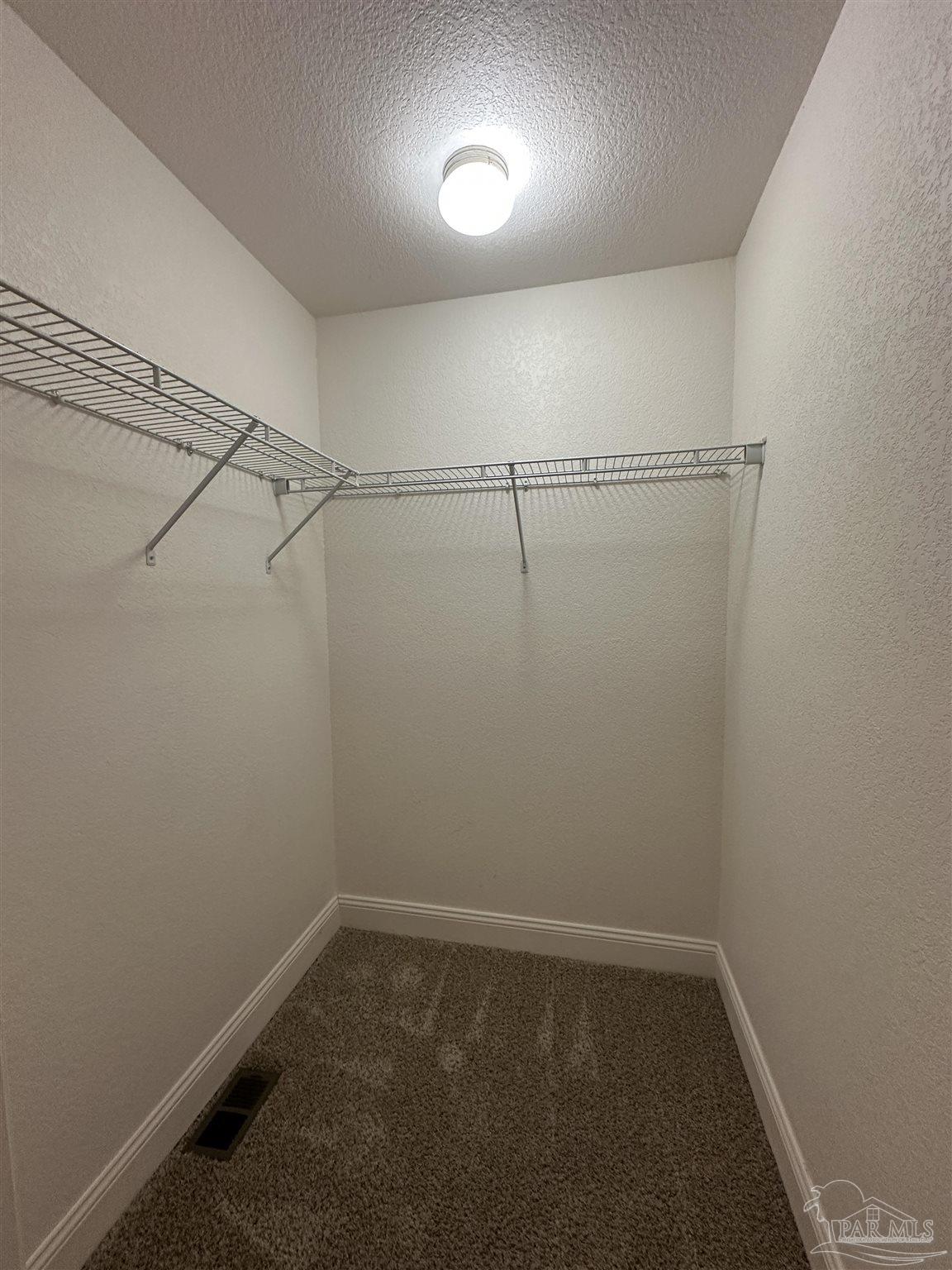 6250 Hamilton Bridge Road, Unit B Milton, FL 32570 - Photo 7 of 16 a view of a room with racks on the wall