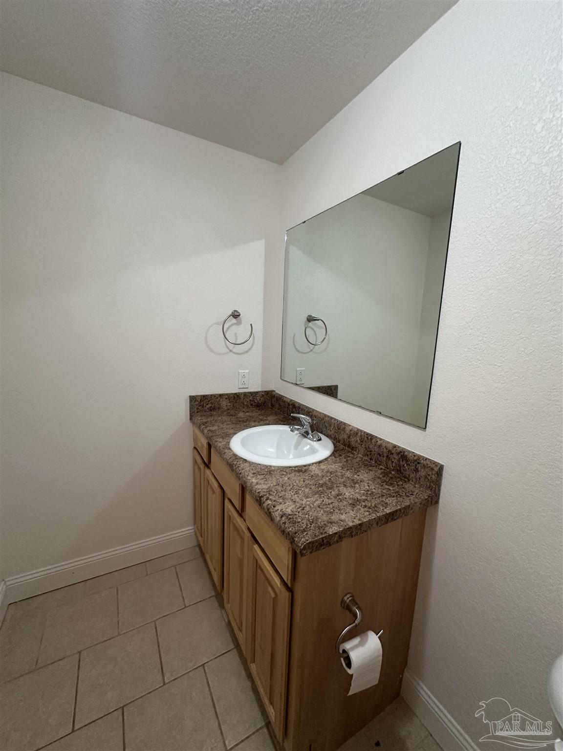 6250 Hamilton Bridge Road, Unit B Milton, FL 32570 - Photo 9 of 16 a bathroom with a granite countertop sink and a mirror