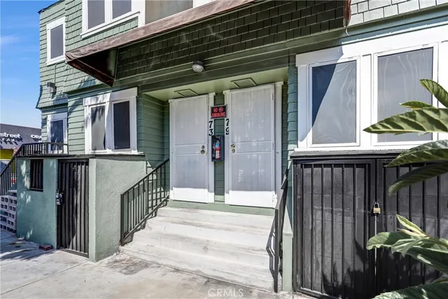 a view of a house with a window and wooden fence