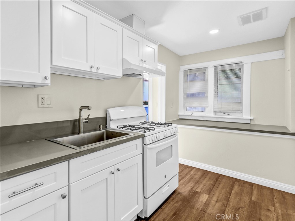 73 South Michigan Avenue Pasadena, CA 91106 - Photo 8 of 17 a kitchen with granite countertop white cabinets and a stove