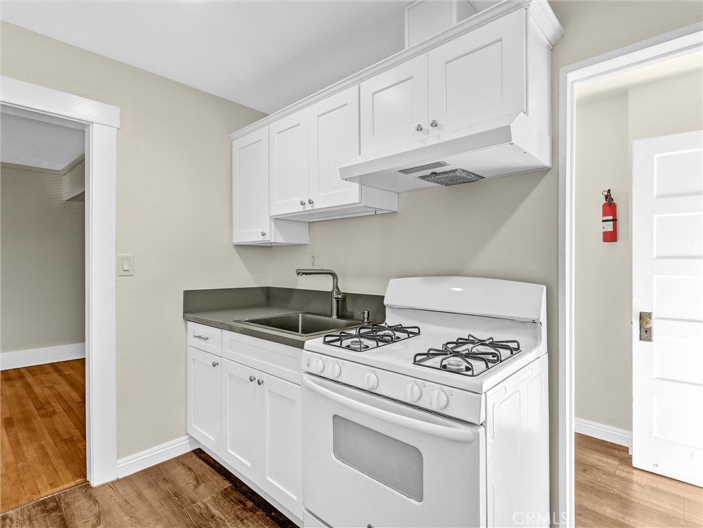 73 South Michigan Avenue Pasadena, CA 91106 - Photo 9 of 17 a kitchen with white cabinets and appliances
