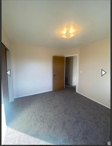 102 East Richelman Lane Wellington, UT 84542 - Photo 9 of 39 Unfurnished bedroom featuring baseboards and carpet flooring
