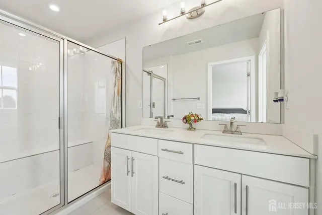 a bathroom with a double vanity sink mirror and