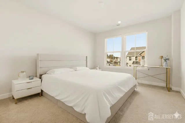 a bedroom with a bed and a large window