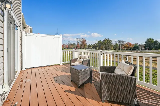 a balcony with wooden floor and furniture
