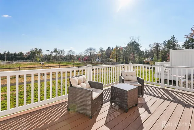 a view of a chair and table on the wooden deck