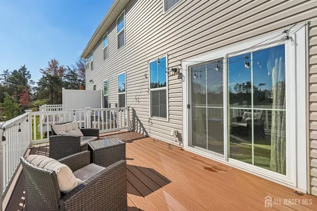 a balcony with furniture and a potted plant