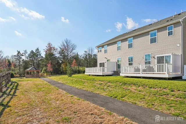 a house view with swimming pool in front of it