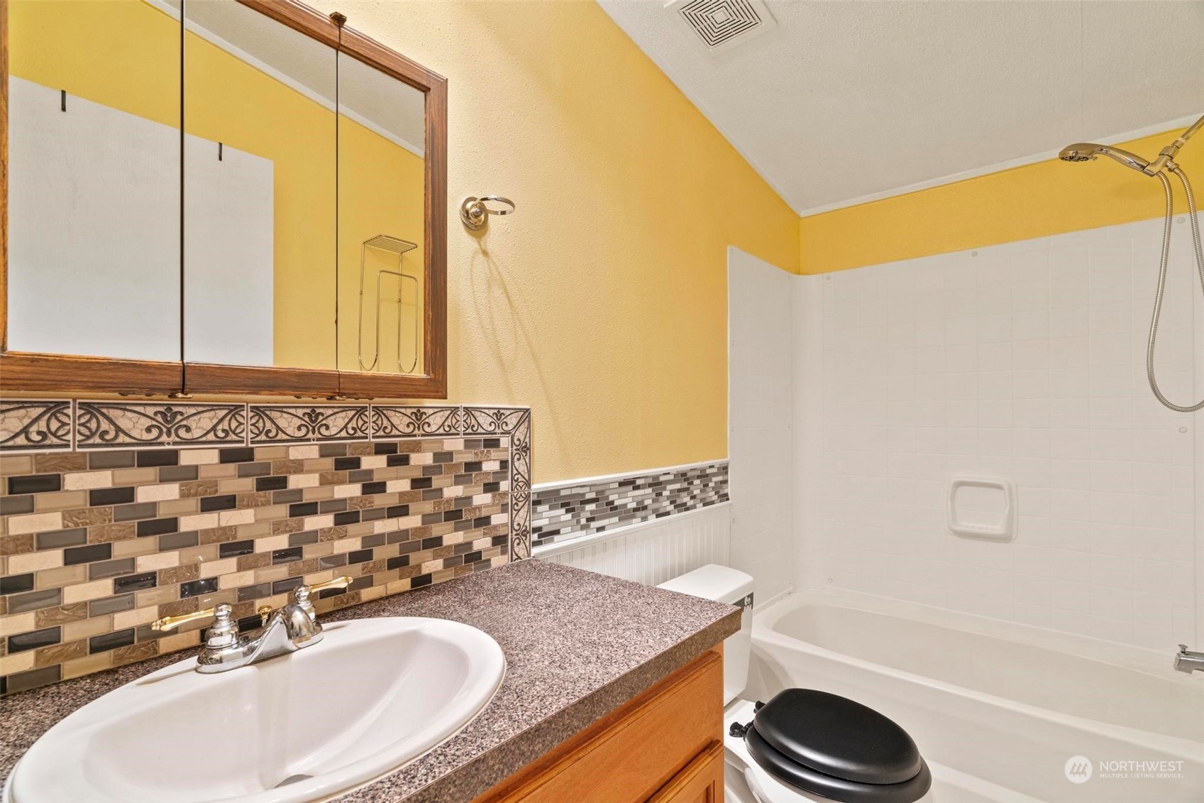10239 185th Avenue Southwest, Unit 54 Rochester, WA 98579 - Photo 14 of 24 a bathroom with a granite countertop sink and a mirror