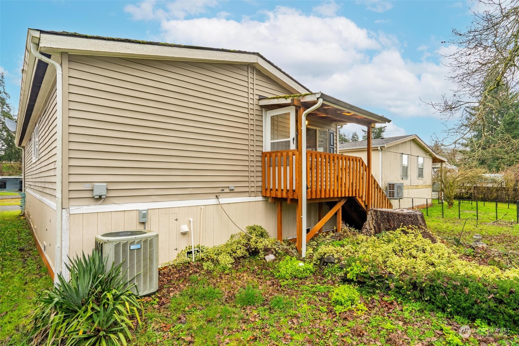 10239 185th Avenue Southwest, Unit 54 Rochester, WA 98579 - Photo 19 of 24 a front view of a house with a yard