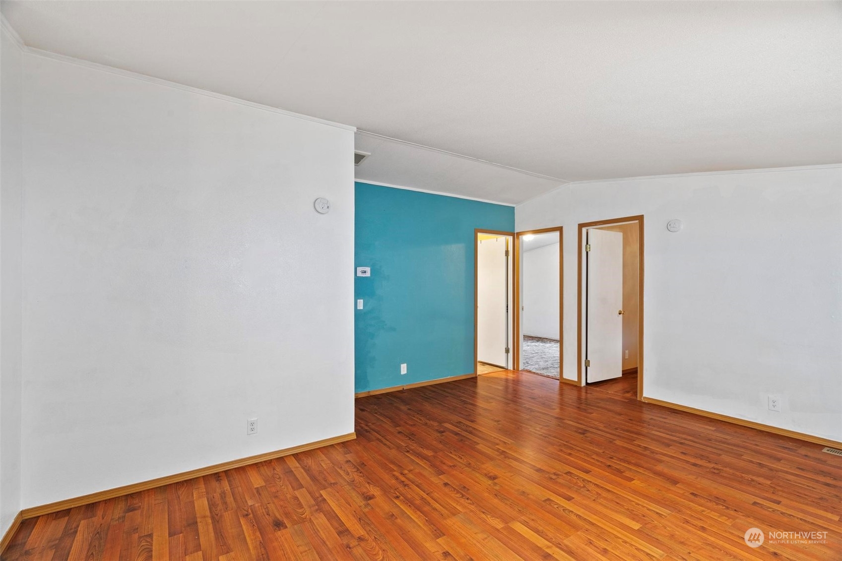10239 185th Avenue Southwest, Unit 54 Rochester, WA 98579 - Photo 7 of 24 an empty room with wooden floor and closet