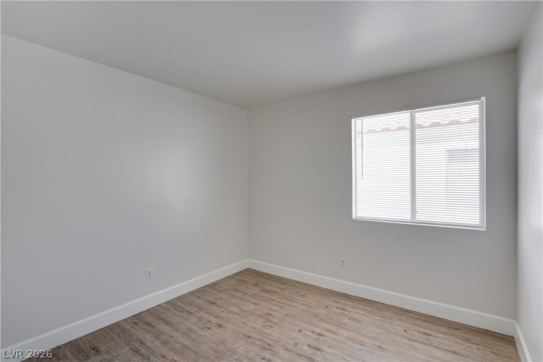 9660 Crystal Ridge Road Las Vegas, NV 89123 - Photo 6 of 13 Sun-filled room featuring wood flooring and clean, minimalist design.