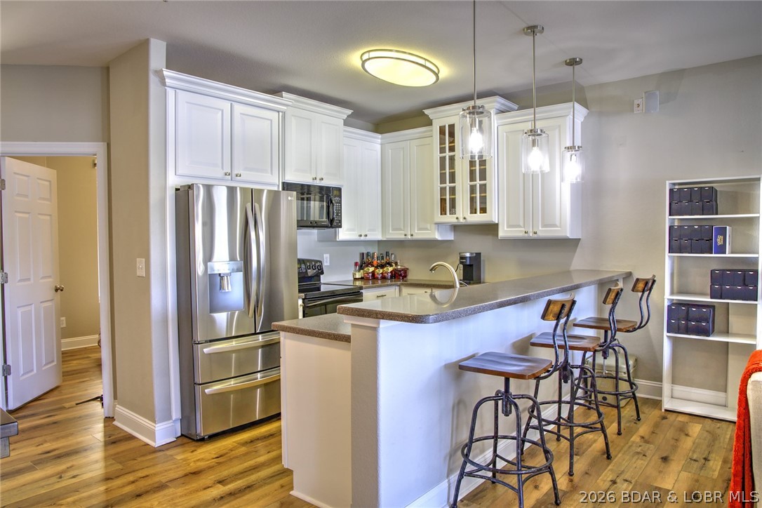 275 Flynn Road, Unit 106 Lake Ozark, MO 65049 - Photo 5 of 39 The kitchen is bright & open with 42" upper cabine