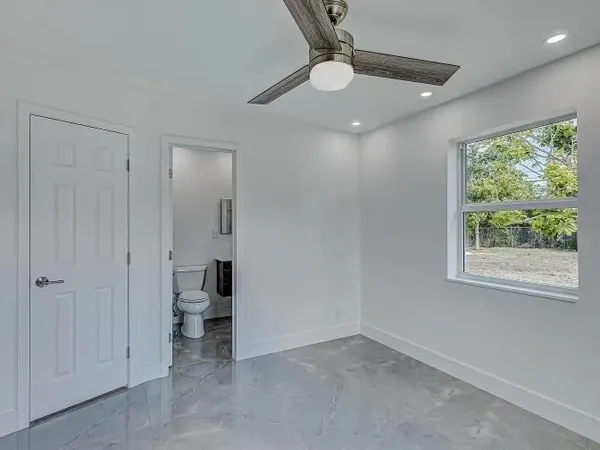 an empty room with windows and closet