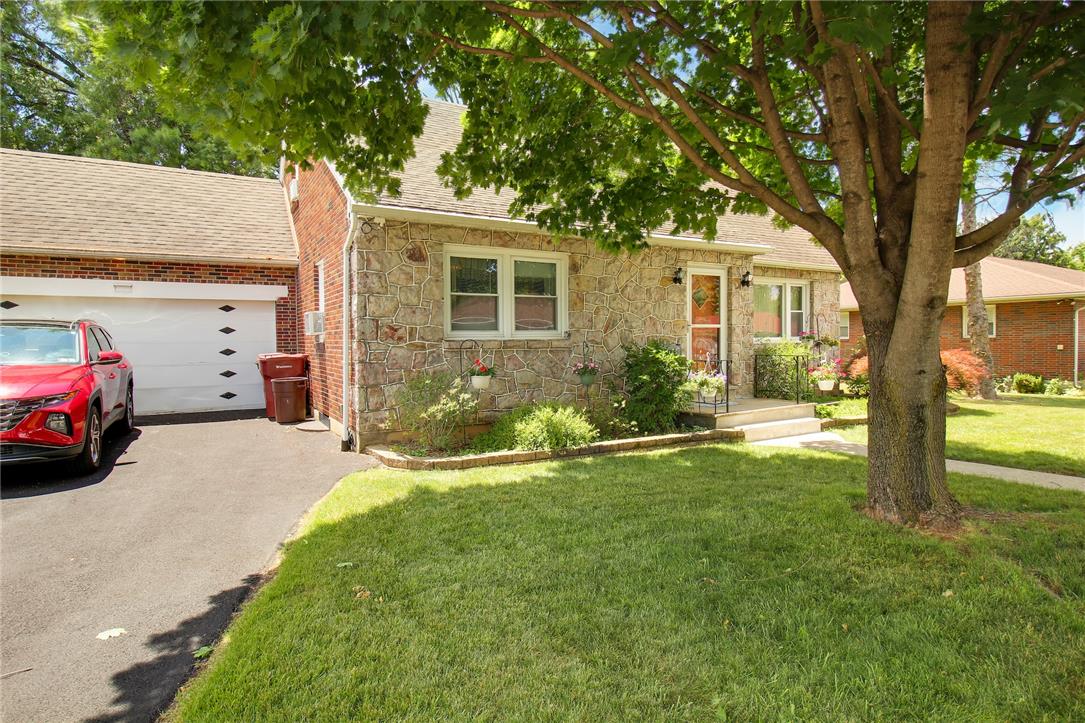 1256 Ridge Avenue Whitehall, PA 18052 - Photo 3 of 43 Stone and brick facade with an attached garage, nestled beneath a mature shade tree.