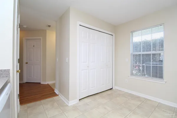 an empty room with windows and closet