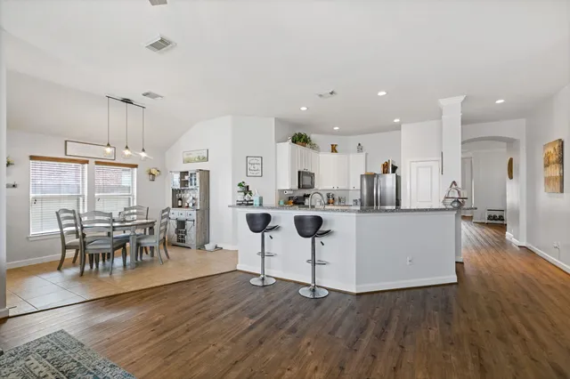 a living room with furniture and kitchen view
