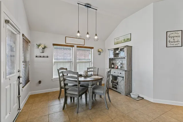 a large kitchen with granite countertop a sink and cabinets