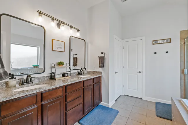 a spacious bedroom with a bed and a chandelier