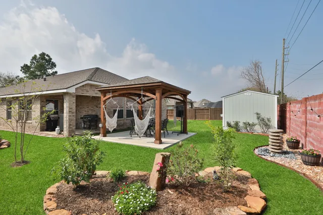 a view of a porch with furniture and garden