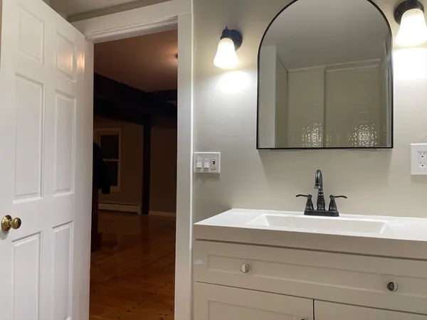 a bathroom with a sink and a mirror