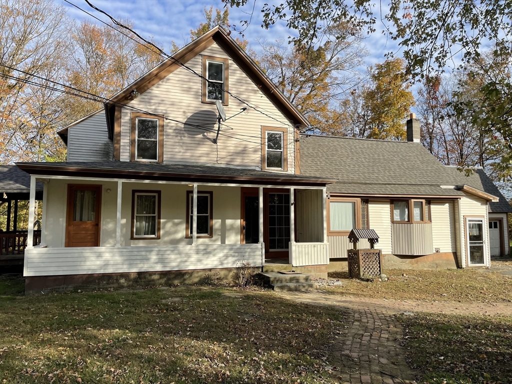 719 Mt Hermon Station Road Northfield, MA 01360 - Photo 2 of 41 a front view of a house with a yard garage and outdoor seating