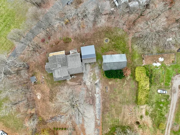 an aerial view of a house with a yard