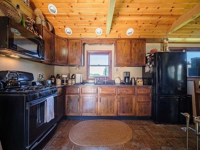 4909 West Edgewood Road Dixon, IL 61021 - Photo 27 of 96 a kitchen with stainless steel appliances granite countertop a stove a sink dishwasher and a refrigerator