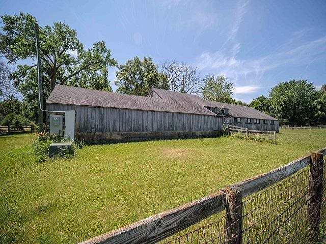 4909 West Edgewood Road Dixon, IL 61021 - Photo 41 of 96 a view of a swimming pool with a bench and trees