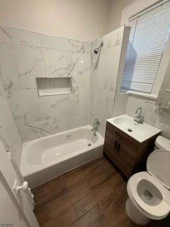 a bathroom with a sink a toilet and bathtub