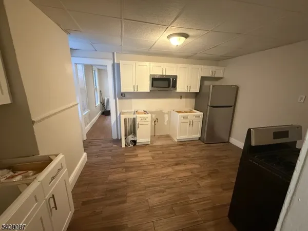 a view of kitchen with furniture and wooden floor