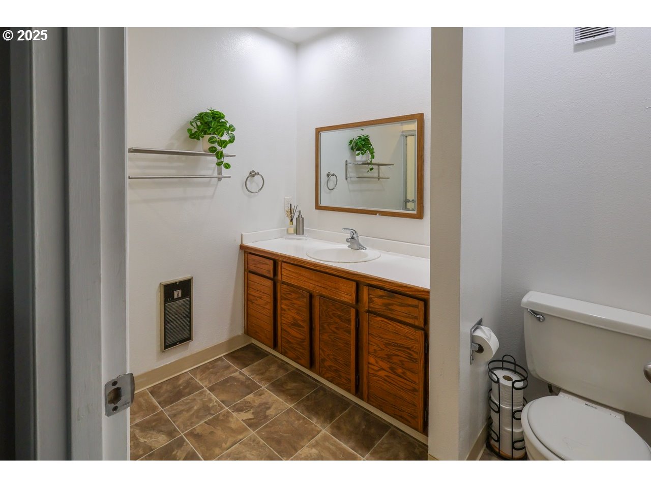 7824 Northeast Loowit Loop, Unit 70 Vancouver, WA 98662 - Photo 19 of 26 a bathroom with a toilet sink and mirror