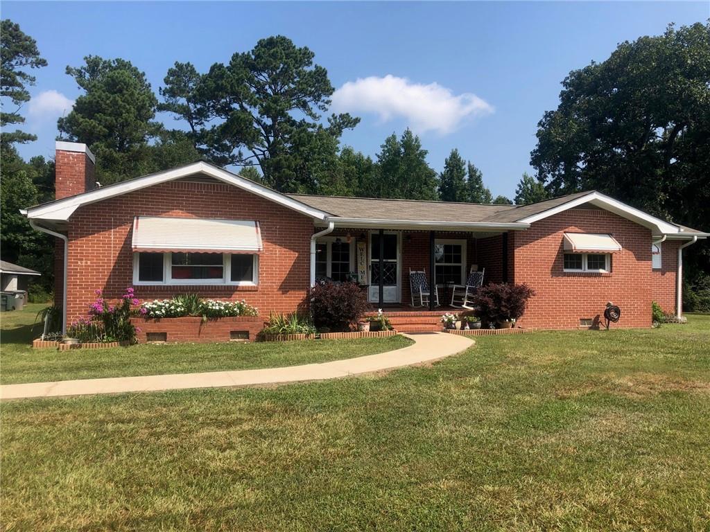 287 Skinners Bypass Road Milner, GA 30257 - Photo 1 of 1 a front view of house with yard outdoor seating and barbeque oven