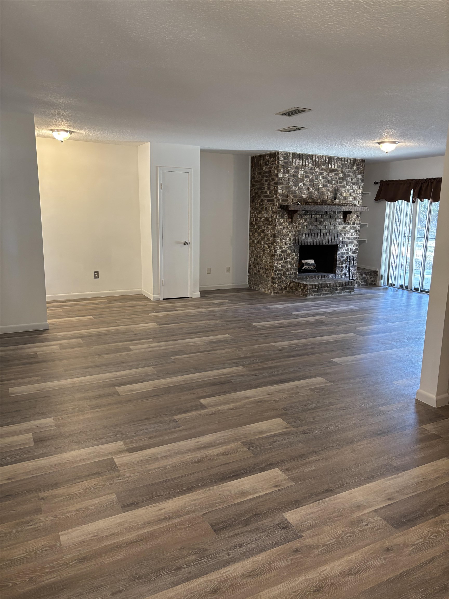 3421 Red Cloud Trail St. Augustine, FL 32086 - Photo 4 of 19 a view of empty room with wooden floor and fireplace