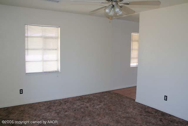 4365 South Tyler Street Amarillo, TX 79110 - Photo 2 of 6 an empty room with a window and a chandelier fan