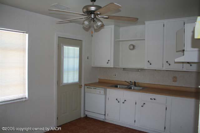 4365 South Tyler Street Amarillo, TX 79110 - Photo 3 of 6 a kitchen with cabinets appliances and a window
