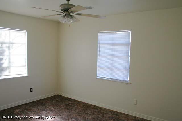 4365 South Tyler Street Amarillo, TX 79110 - Photo 4 of 6 an empty room with a window and a fan